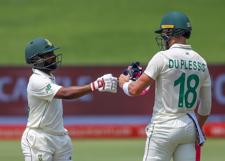 Temba Bavuma of South Africa being congratulated by Faf du Plessis of South Africa after reaching his fifty during day 3 of the 1st Betway Test (WTC) match between South Africa and Sri Lanka at SuperSport Park on December 28, 2020 in Pretoria, South Africa.