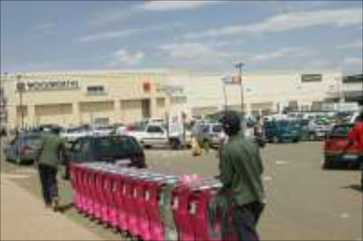 WILL TRAVEL: Workers push trolleys at the new Jabulani Mall in Soweto. Pic. Antonio Muchave.26/19/06. © Sowetan.