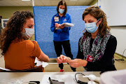 Healthcare workers take part in a rehearsal for the administration of the Pfizer Covid-19 vaccine at Indiana University Health in Indianapolis, Indiana, US. 