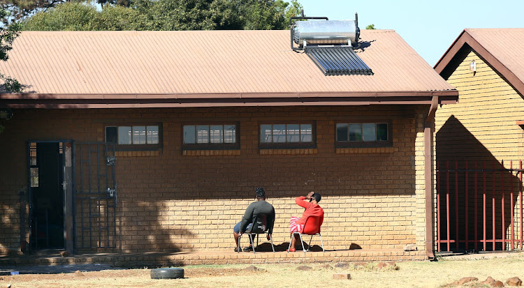 Teachers at Inkanyezi Primary School in Phiri, Soweto, bask in the sun after pupils failed to arrive for classes.
