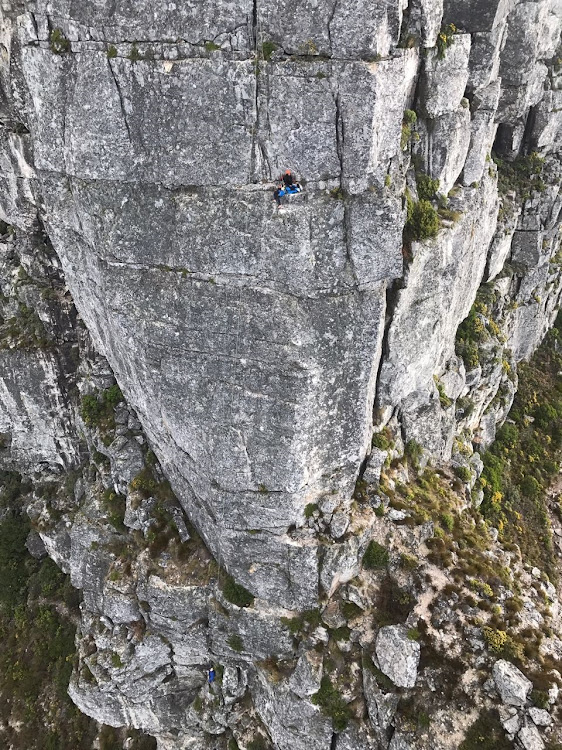 The climbers dangling on ropes as seen from the Skymed rescue helicopter.