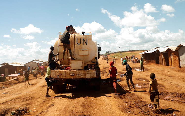 Congolese children play as they ride atop a UN water truck in Rhoe camp for internally displaced people in Djugu territory, Ituri province, northeast DRC, on April 19 2023. File photo.