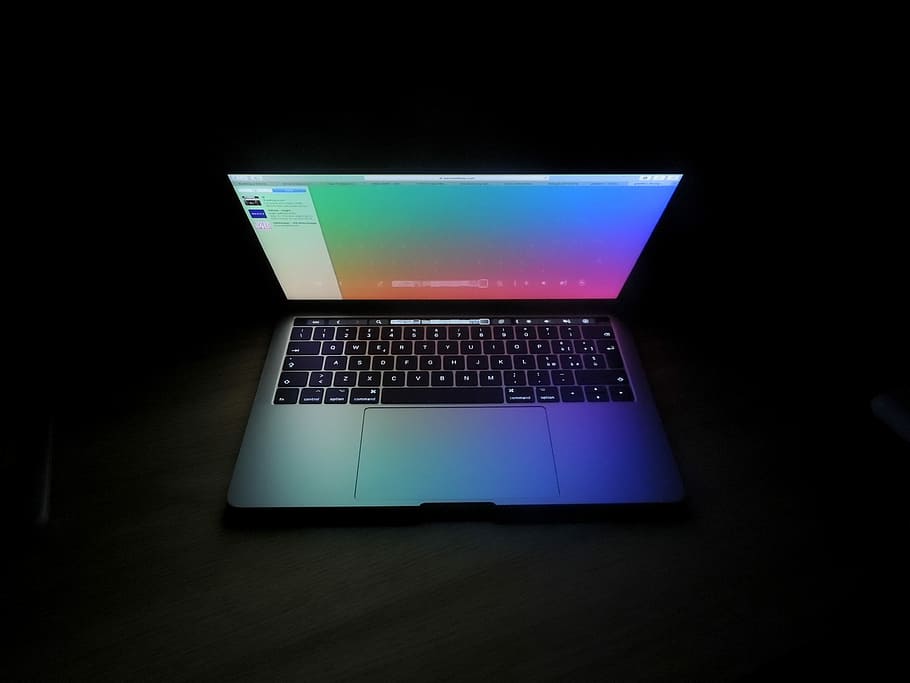 This image shows the laptop in curved shape in the black shade background.