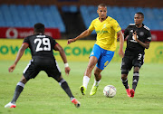 Rivaldo Coetzee of Mamelodi Sundowns is challenged by Thembinkosi Lorch of Orlando Pirates in the DStv Premiership match at Loftus Versfeld  in Pretoria on December 17 2021.