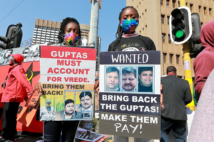 Participants from Ahmed Kathrada Foundation, OUTA, SACP, Defend Our Democracy Campaign and Right To Know protest outside the Zondo Commission during the appearance of President Cyril Ramaphosa on August 12, 2021.