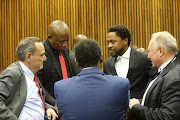 Mbuyiseni Ndlozi and Julius Malema consult with their legal representative during an adjournment at the Randburg magistrate's court in their case for an assault which is alleged to have happened during the funeral of the late Winnie Mandela in 2018.