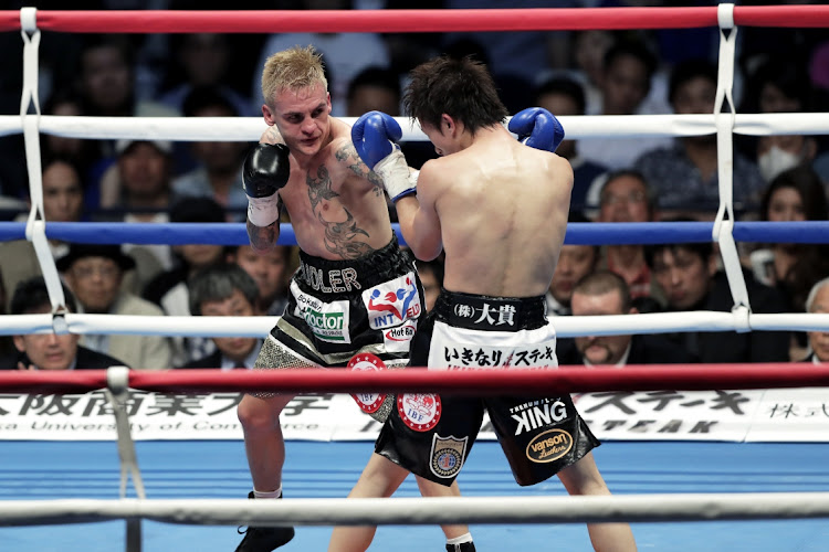 Hekkie Budler, left, in action while winning the IBF, WBA and The Ring magazine junior-flyweight belts from Ryoichi Taguchi of Japan in May 2018.