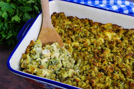 Spooning the Cheesy Chicken Broccoli Stuffing Bake.