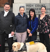 Advocate Andrew Snider, Gail Glover from the Guide Dog Association, Amanda Bester with Reo, and lawyer Deirdre Venter outside the Cape Town High Court. 