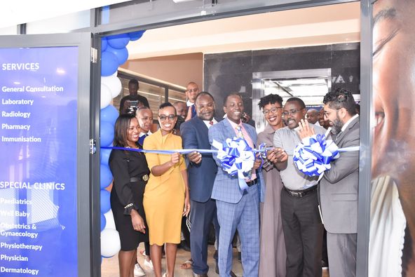 Avenue healthcare hospital CEO Imran Osman (left) claps as Kiambu health CEC Kinuthia Maina leads guests and doctors to open the hospital's clinic in Kikuyu town on Saturday, February 25.