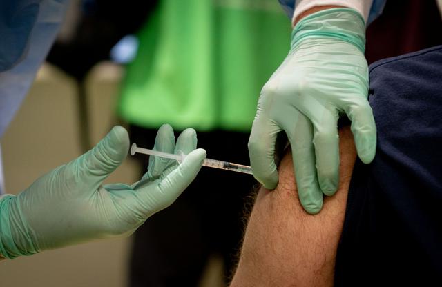 A doctor vaccinates a nurse with AstraZeneca's COVID-19 vaccine at Berlin's former Tegel TXL airport, amid the spread of the coronavirus disease (COVID-19) in Berlin, Germany, February 10, 2021.