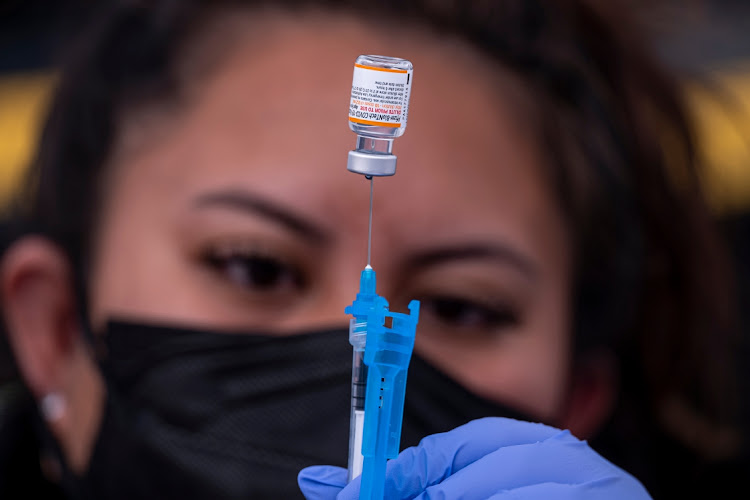 A healthcare worker prepares a dose of Pfizer-BioNTech Covid-19 vaccine at a vaccination site in San Francisco, US, on Monday January 10 2022.