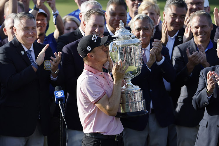 Justin Thomas of the USA kisses the Wanamaker Trophy after winning the playoff round against Will Zalatoris of the USA during the final round of the 2022 PGA Championship at Southern Hills Country Club in Tulsa, Oklahoma on May 22 2022.