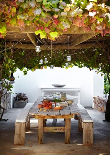 The stylish owner of this historic villa says its outdoor living area – which features a swimming pool as well as this delightful vine-covered gazebo — is like ‘having an extra room’.