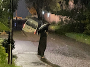 A taxi was trapped in a sinkhole in Morningside, Durban, as rain pounded the city on Thursday night and Friday morning.