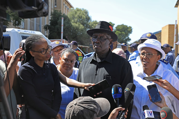 Police minister Bheki Cele addresses the media outside Sophiatown police station after shooting incidents in Westbury, Johannesburg.