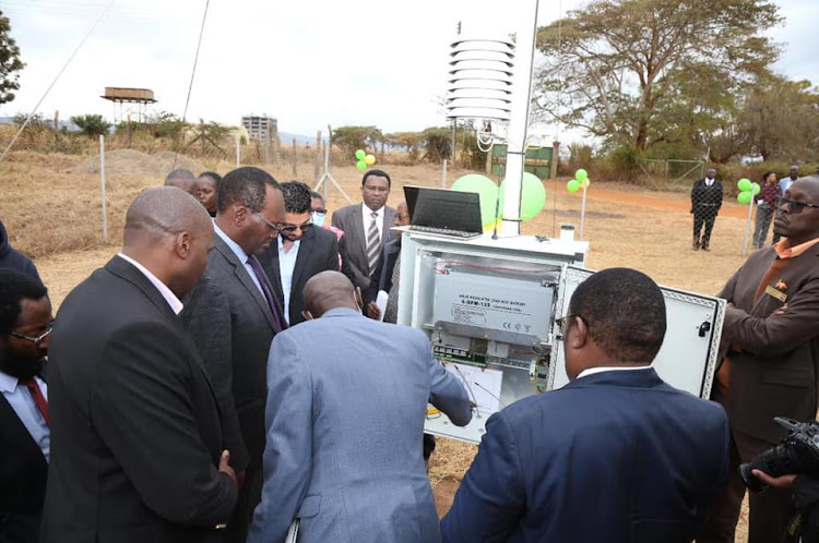 Environment PS Dr Chris Kiptoo (glasses) looks at the new Automatic Weather Station at the Agricultural Training Centre in Machakos county on August 3.