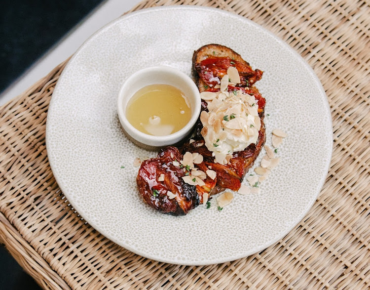 Slow roasted roma tomatoes on toasted rye with cream cheese, honey & toasted almonds from Fables in the Midlands.