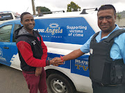 Nthutuko Buthelezi is congratulated by Blue Security officer, Nischal Ramesh, after he saved a four-year-old from drowning.