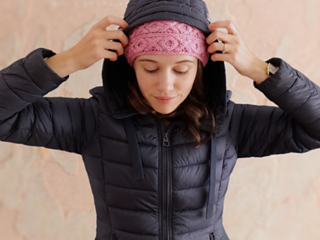 woman wearing a pink cable knit headband