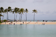 Tourists enjoy a gorgeous day at the beach in Waikiki, Hawaii. 