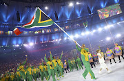 Flag-bearer Wayde Van Niekerk (RSA) of South Africa leads his contingent during the opening ceremony. REUTERS/Kai Pfaffenbach