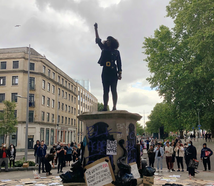 Resident Jen Reid rising her fist stands on the empty plinth previously occupied by the statue of slave trader Edward Colston, in Bristol, Britain June 7, 2020, in this image obtained from social media.