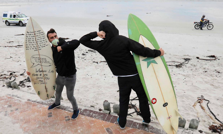 Surfers greet with the new elbow touch to maintain social distancing.