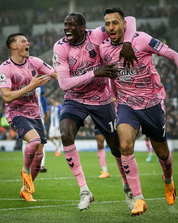 Everton's Abdoulaye Doucoure and Dwight McNeil celebrate during their match against Brighton