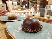 Kahvé Road's chocolate-robed espresso dome filled with a light espresso sponge and rich mousse on a shortbread and cocoa nib base.