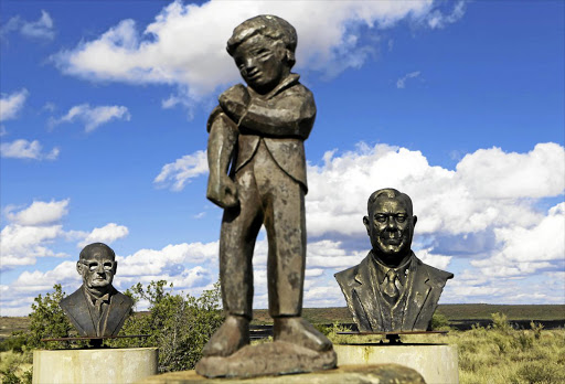 NON-SPEAKING ROLES: Busts of DF Malan and Hendrik Verwoerd, former heads of state and abiding symbols of Afrikaaner power, flank the logo of the Northern Cape town of Orania.