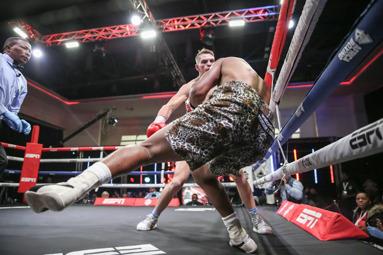 Cayden Truter, his ducky socks visible, rocks Khanyiseni Mbokazi in their fight in Sandton on Thursday night.