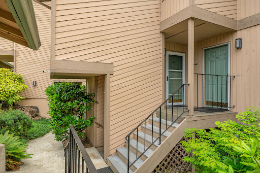 Beige building facade, stairs, two doors in this luxury house for sale in Mountlake Terrace ($549,000)