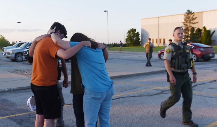 People pray at the CrossRoad Baptist Church parking lot after a shooting at Cornerstone Church in Ames, Iowa, US June 2, 2022.