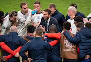 England manager Gareth Southgate talks to his players during the half-time break of extra time in the Uefa Euro 2020 Championship semi-final against Denmark at Wembley Stadium on July 07, 2021.