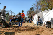 TENT CITY:  Relocated Cape York residents pass the time in Turffontein Picture: Moeletsi Mabe