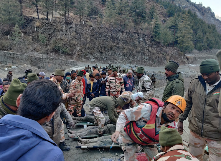 Members of Indo-Tibetan Border Police (ITBP) tend to people rescued after a Himalayan glacier broke and swept away a small hydroelectric dam, in Chormi village in Tapovan in the northern state of Uttarakhand, India,