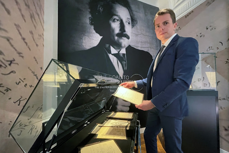 Vincent Belloy, specialist in the books and manuscript department at Christie's, poses with the Einstein-Besso manuscript at Christie's auction house in Paris, France, November 22 2021. Picture: ANTONY PAONE/REUTERS