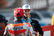 Alex Marquez, rider of EG 0,0 Marc VDS from Spain, talks to his brother Marc Marquez, rider of Repsol Honda Team from Spain, during the World Champion photo during the Gran Premio Motul de la Comunitat Valenciana of MotoGP at Ricardo Tormo Circuit on November 17, 2019 in Cheste, Spain.