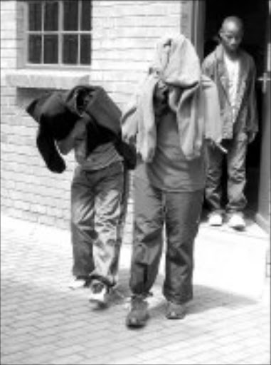 FINGERED: Members of the group that allegedly robbed an SBV security van and killed four guards leave the Mokopane regional court yesterday. Pic. Edward Maahlamela. 28/03/2007. © Sowetan.