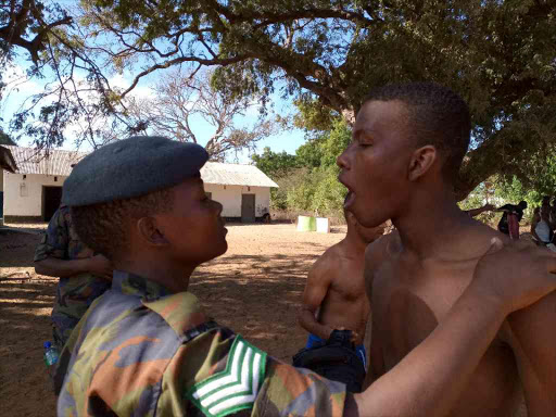 A man's teeth are examined at Kibaki Grounds in Lamu town during KDF's recruitment in Lamu county, February 12, 2018. /PRAXIDES CHETI