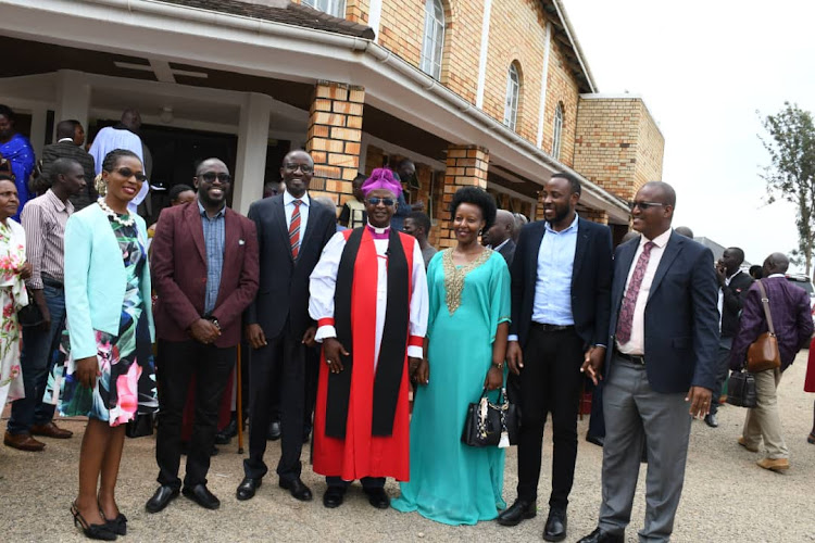 Uganda Baati staff pose with the Bishop