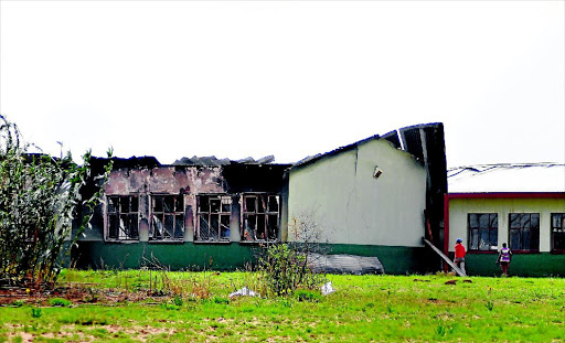BURNT OUT: The blackened Noto High School in Kopela, North West, became a casualty of angry residents who torched it during a protest on Tuesday Photo: Tiro Ramatlhatse