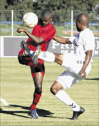 HUFFING AND PUFFING: Jomo Cosmos player Thabiso Hlalele, left, challenges Wits's Sifiso
Vilakazi during their Absa Premiership match at the Vaal University of Technology Stadium
yesterday. Pic: Antonio Muchave. 16/12/2009. © Sowetan.