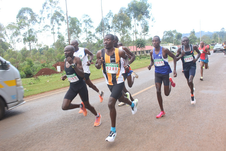 Athletes battle it out in the men's 10kms race along the Kisii-Chemosit Road