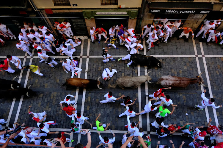 Bulls from the Fuente Ymbro ranch run along Estafeta Street during the fourth running of the bulls during Sanfermines or the festival of San Fermín in Pamplona, Spain.