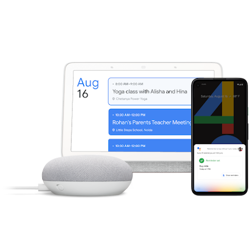 A Google Home, laptop and phone featuring Hey Google