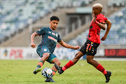 AmaZulu's Ethan Brooks is challenged by Lehlohonolo Mojela of TS Galaxy in the Carling Knockout Cup semifinal at Moses Mabhida Stadium in Durban on Sunday.