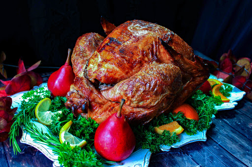 Oil-less fried turkey on a platter ready to be carved.