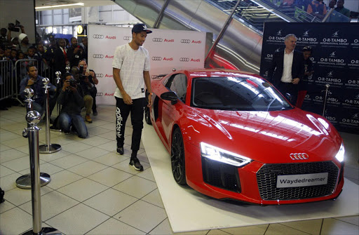 Members of the public as well as school kids came out to give a hero's welcome to Wayde van Niekerk. Wayde van Niekerk, a South African athlete, who broke the 400m world record at the 2016 Rio Olympic games was presented with an Audi R8 on his arrival at OR Tambo International airport Wednesday.The 24-year-old will be loaned a V10 Plus model for one year according to Audi South Africa. Van Niekerk was named as an Audi Sport Ambassadors ahead of the Games earlier in August. PHOTOGRAPH: ALON SKUY